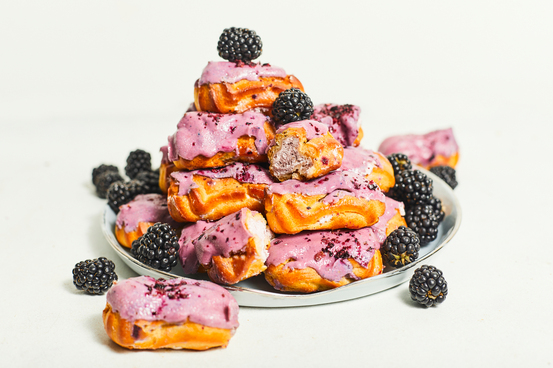 Mini eclairs with blackberry cream filling