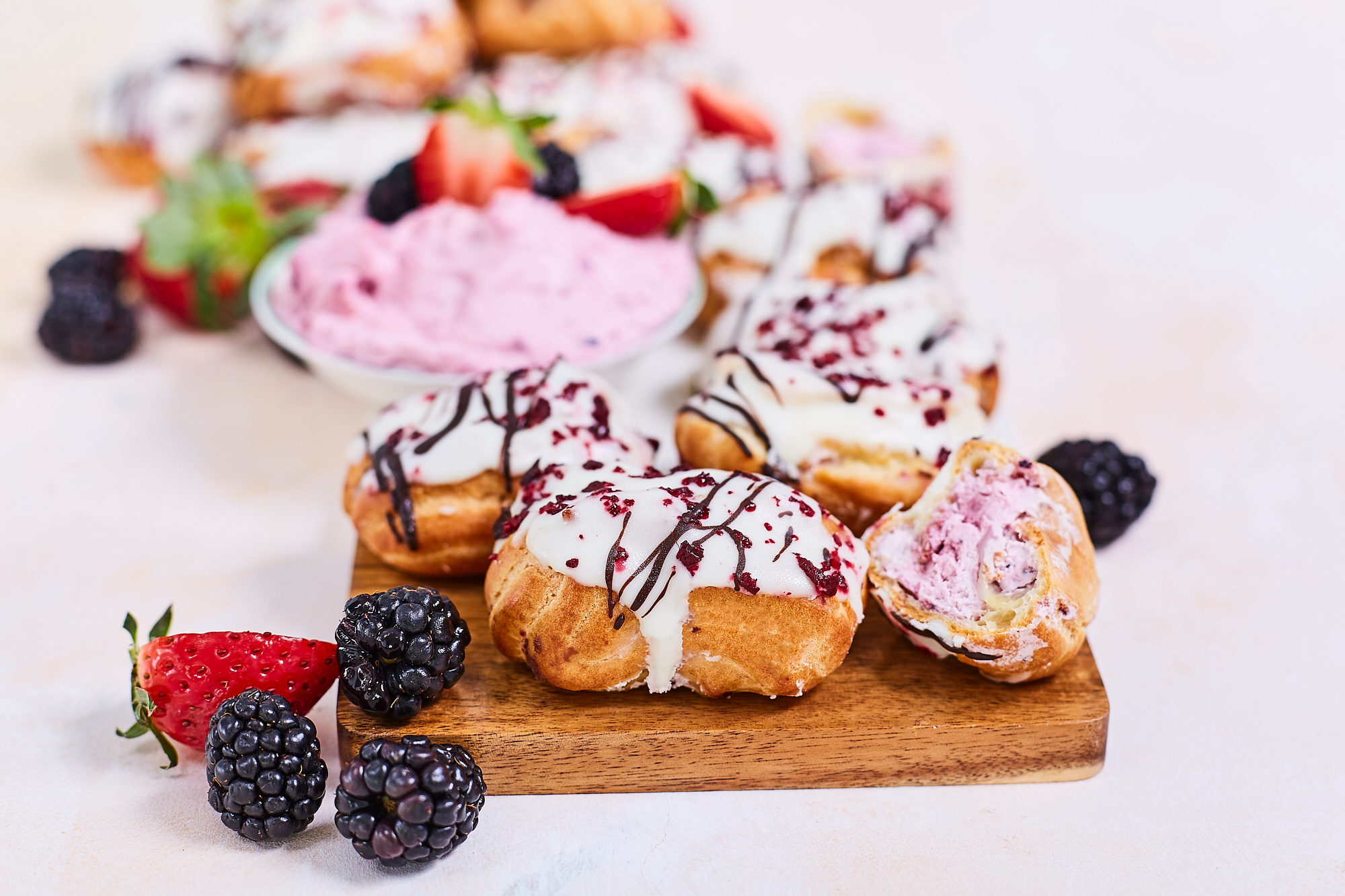 Mini Eclairs with berry filling in white chocolate